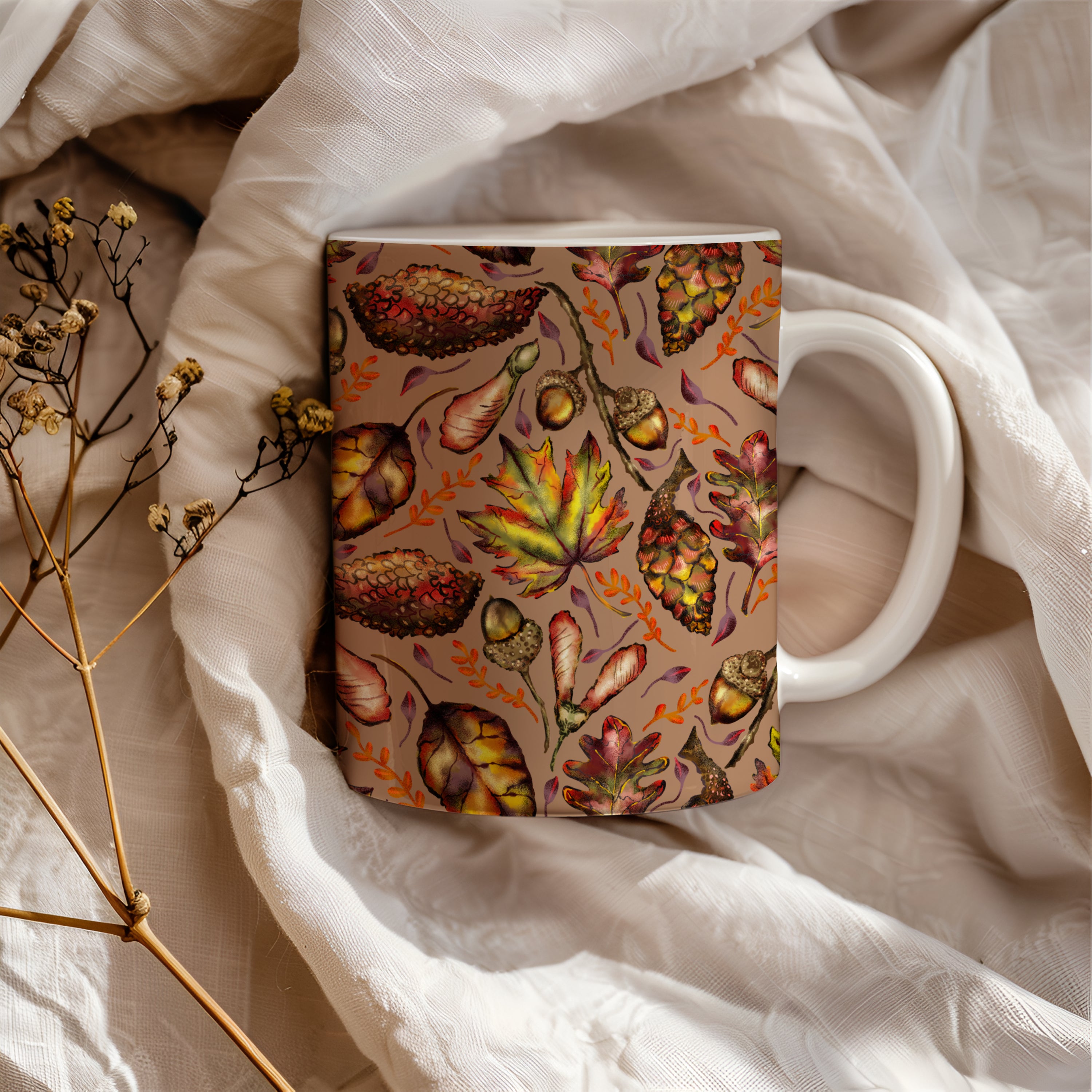 Mug with autumn-themed design on a soft fabric background