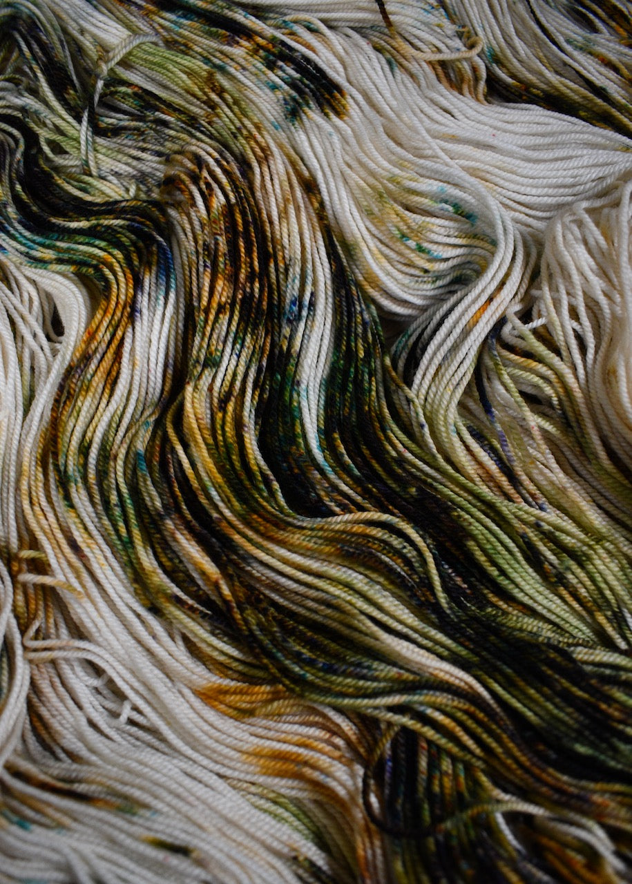 Green and rust speckled hand dyed merino and cashmere sock yarn.