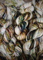 Green and rust speckled hand dyed merino and cashmere sock yarn.