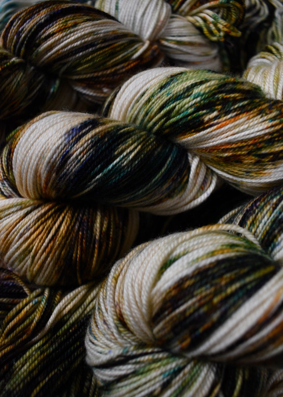 Green and rust speckled hand dyed merino and cashmere sock yarn.