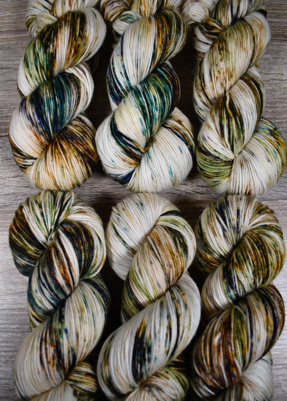 Green and rust speckled hand dyed merino and cashmere sock yarn.