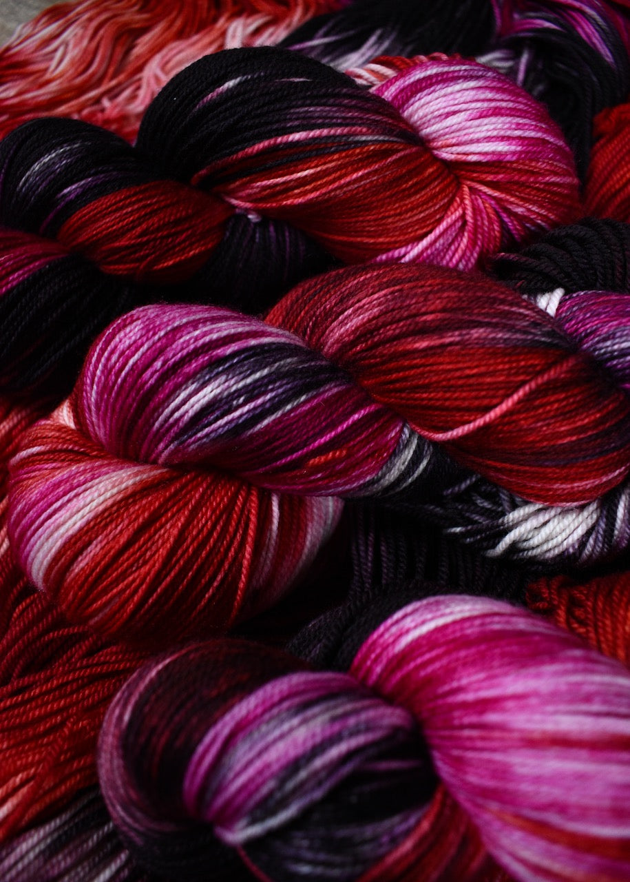 various red colour hand dyed merino cashmere sock yarn.