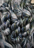 Bamboo sock yarn hand dyed with green speckles.