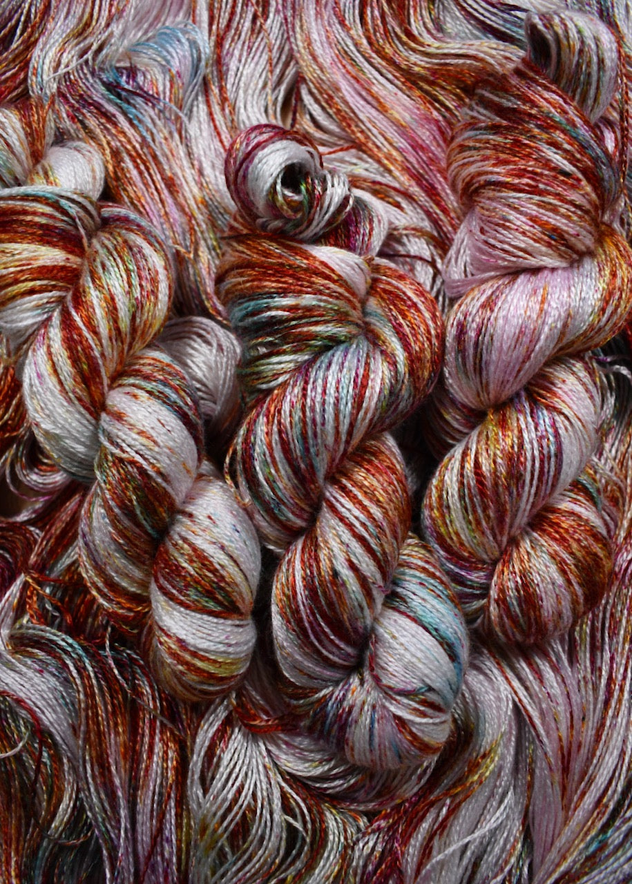 Pink speckled hand dyed bamboo sock yarn.