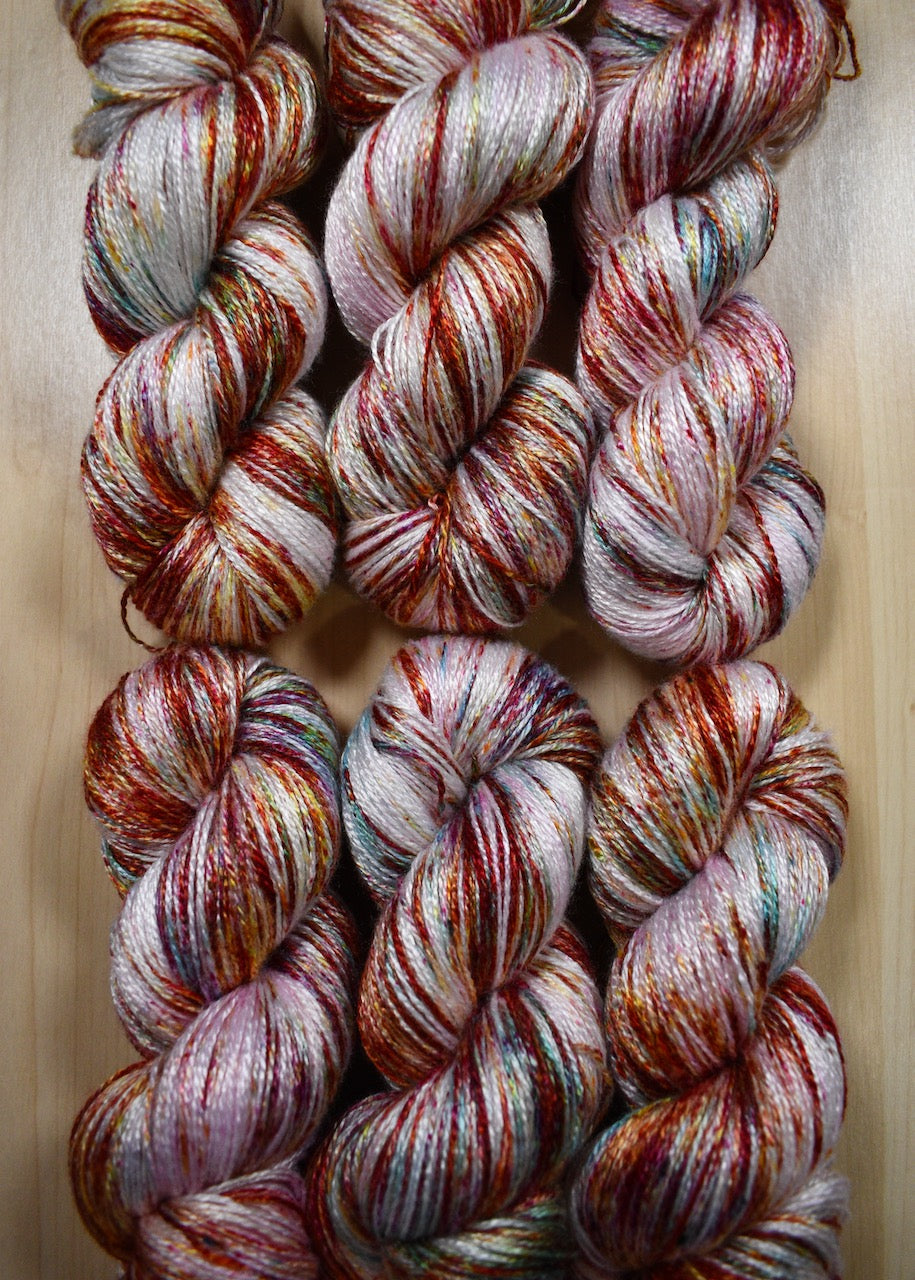 Pink speckled hand dyed bamboo sock yarn.