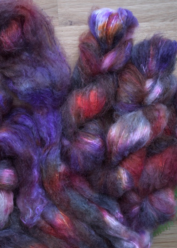 Red and purple hand dyed mohair dk weight yarn.