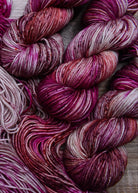 Hand dyed pink speckled merino wool yarn.