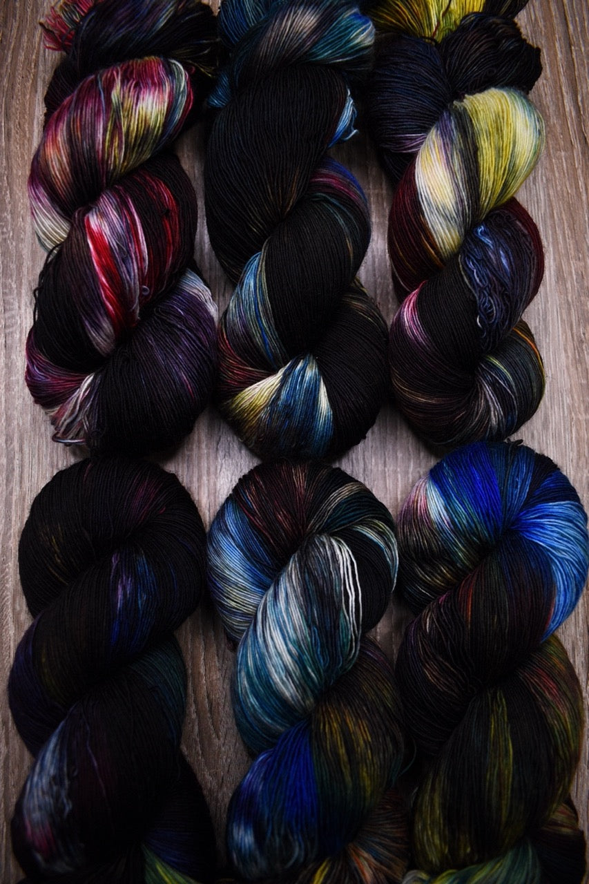 Dark rainbow colour hand dyed merino lace yarn.