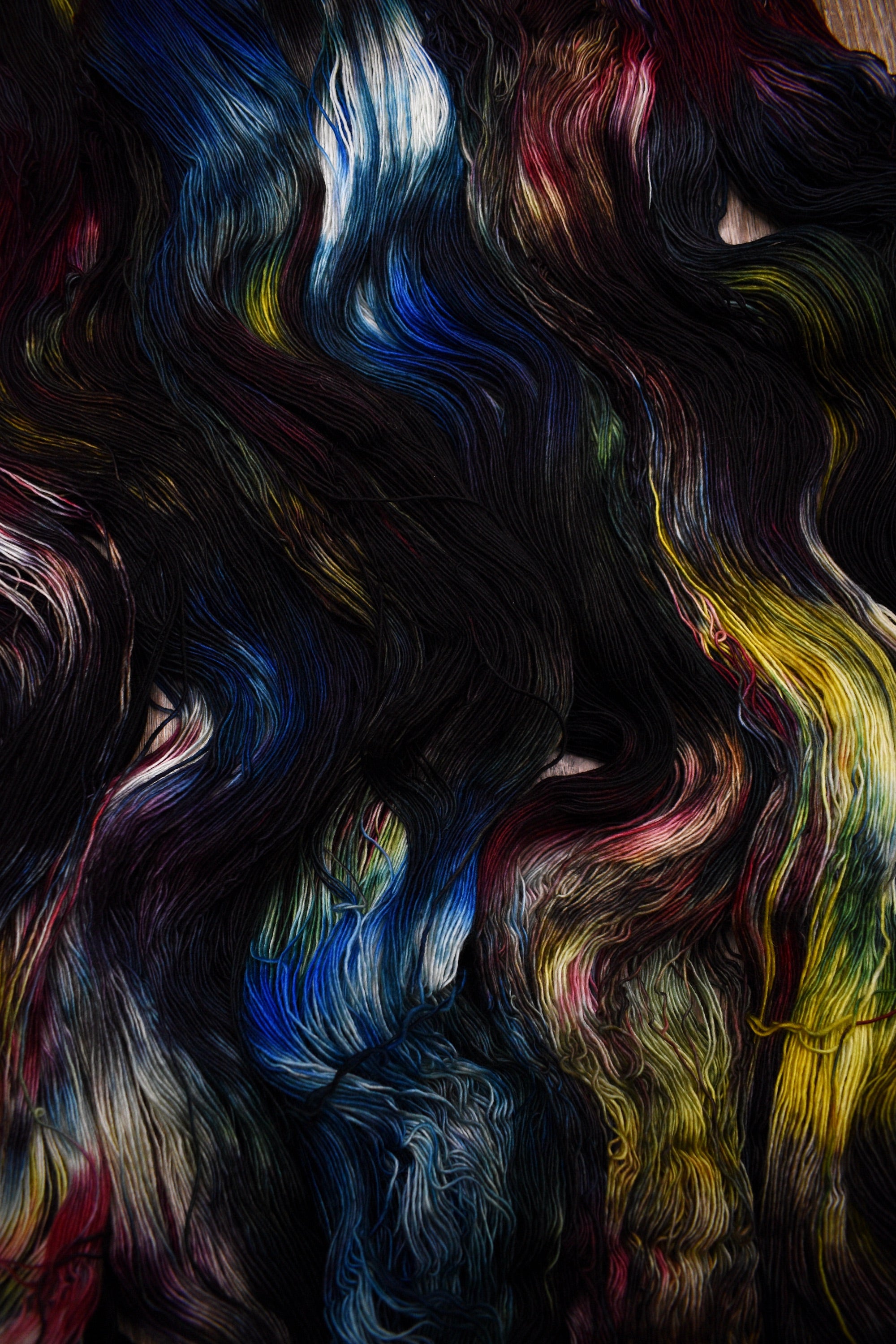 Dark rainbow colour hand dyed merino lace yarn.