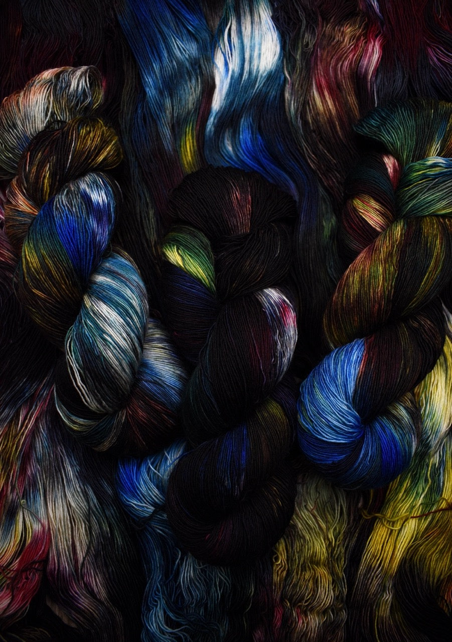 Dark rainbow colour hand dyed merino lace yarn.