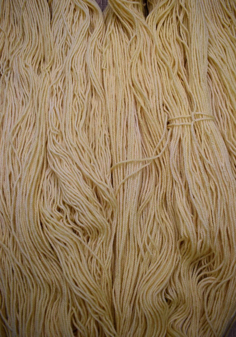 Hand dyed wool yarn, light yellow.