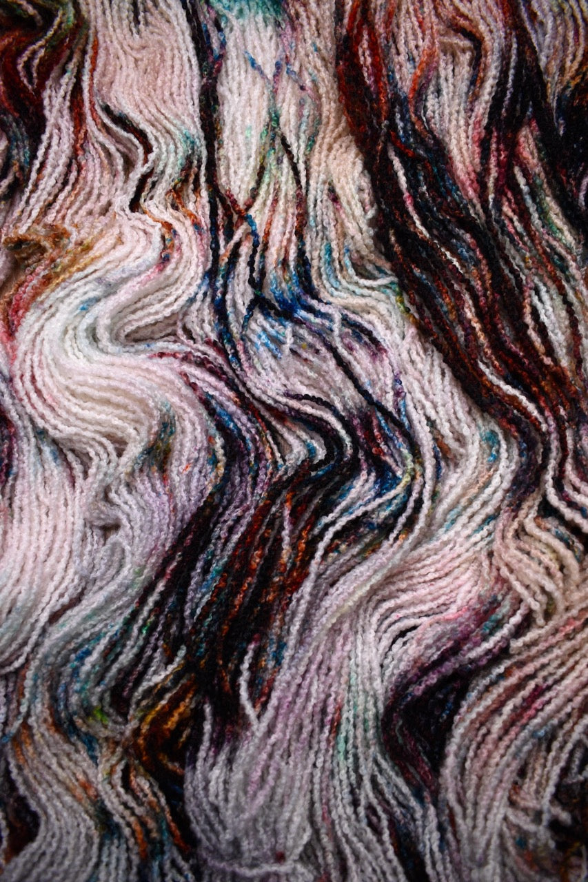 Hand dyed wool boucle yarn in colour African Violet.