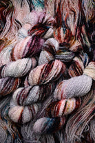 Hand dyed wool boucle yarn in colour African Violet.