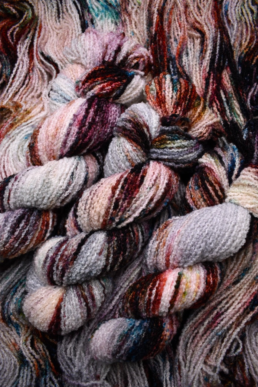 Hand dyed wool boucle yarn in colour African Violet.