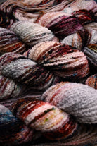 Hand dyed wool boucle yarn in colour African Violet.