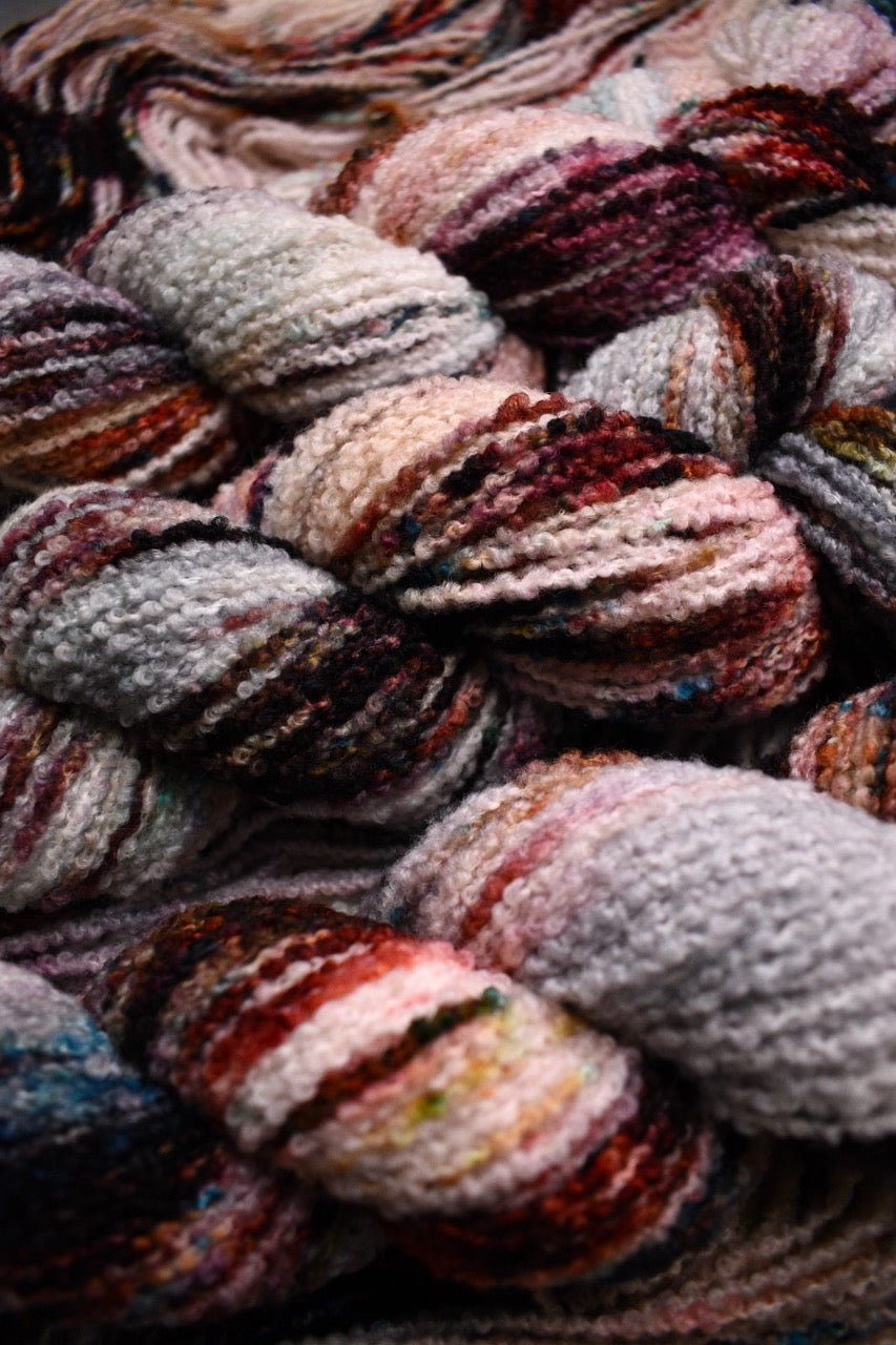 Hand dyed wool boucle yarn in colour African Violet.