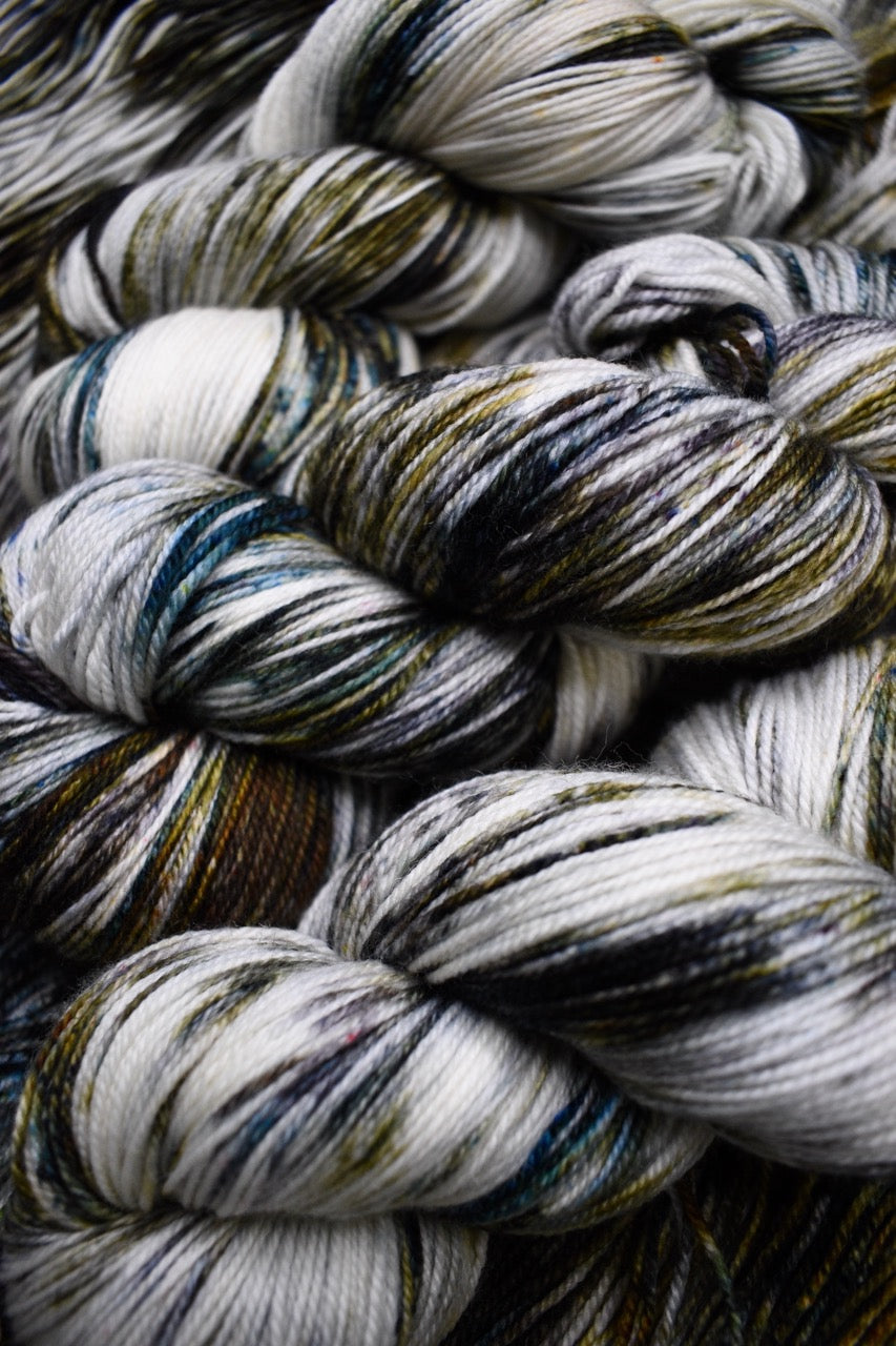 Green and brown speckled hand dyed merino sock yarn.