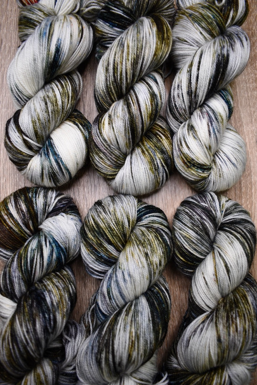 Green and brown speckled hand dyed merino sock yarn.