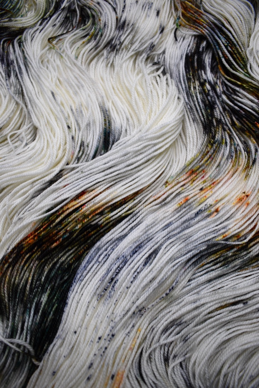 Speckled neutral gray colour hand dyed merino sock yarn.