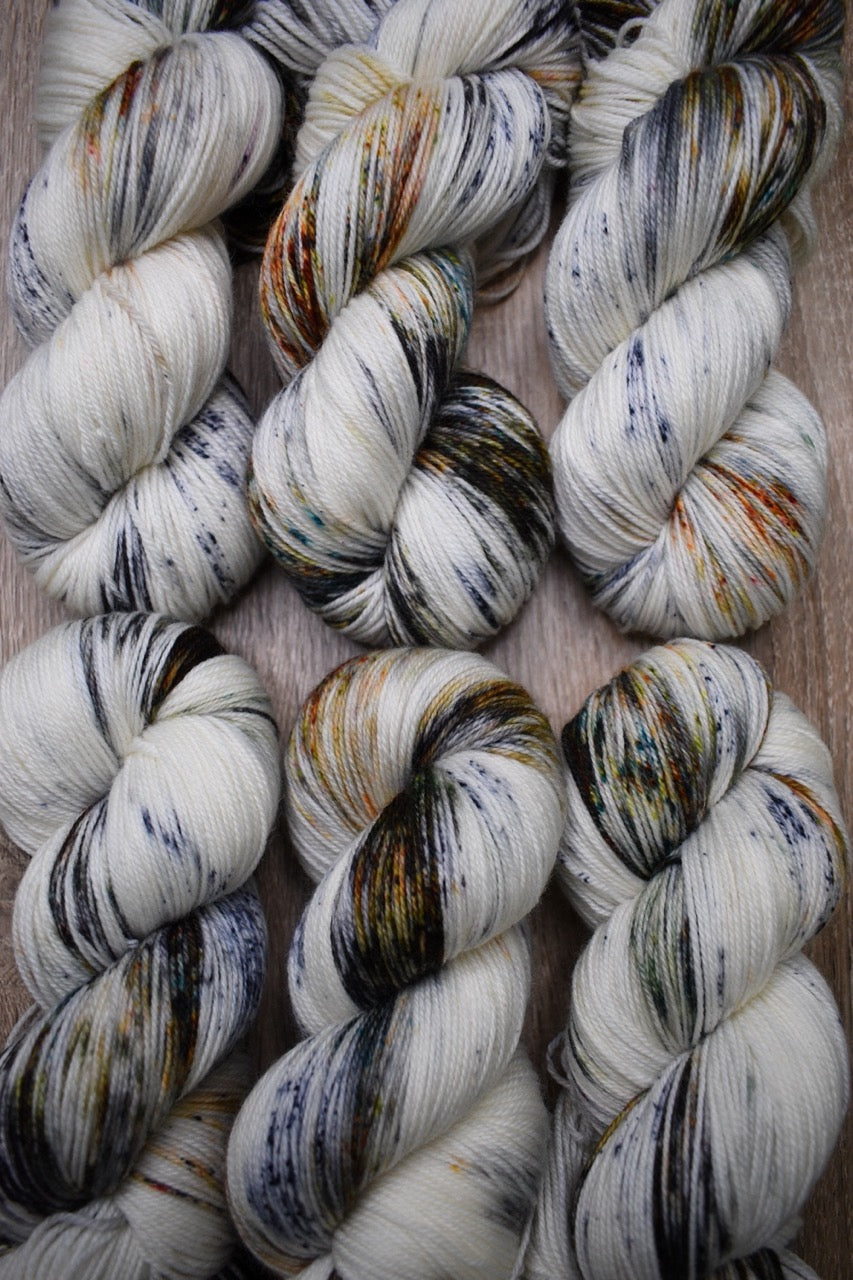 Speckled neutral gray colour hand dyed merino sock yarn.