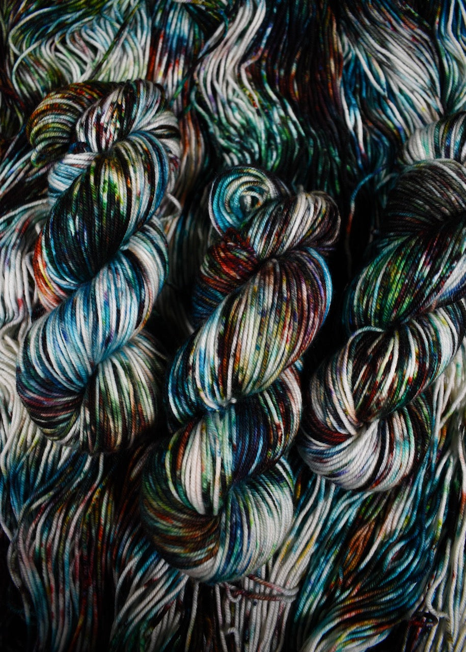 Multi colour speckled merino hand dyed worsted yarn.