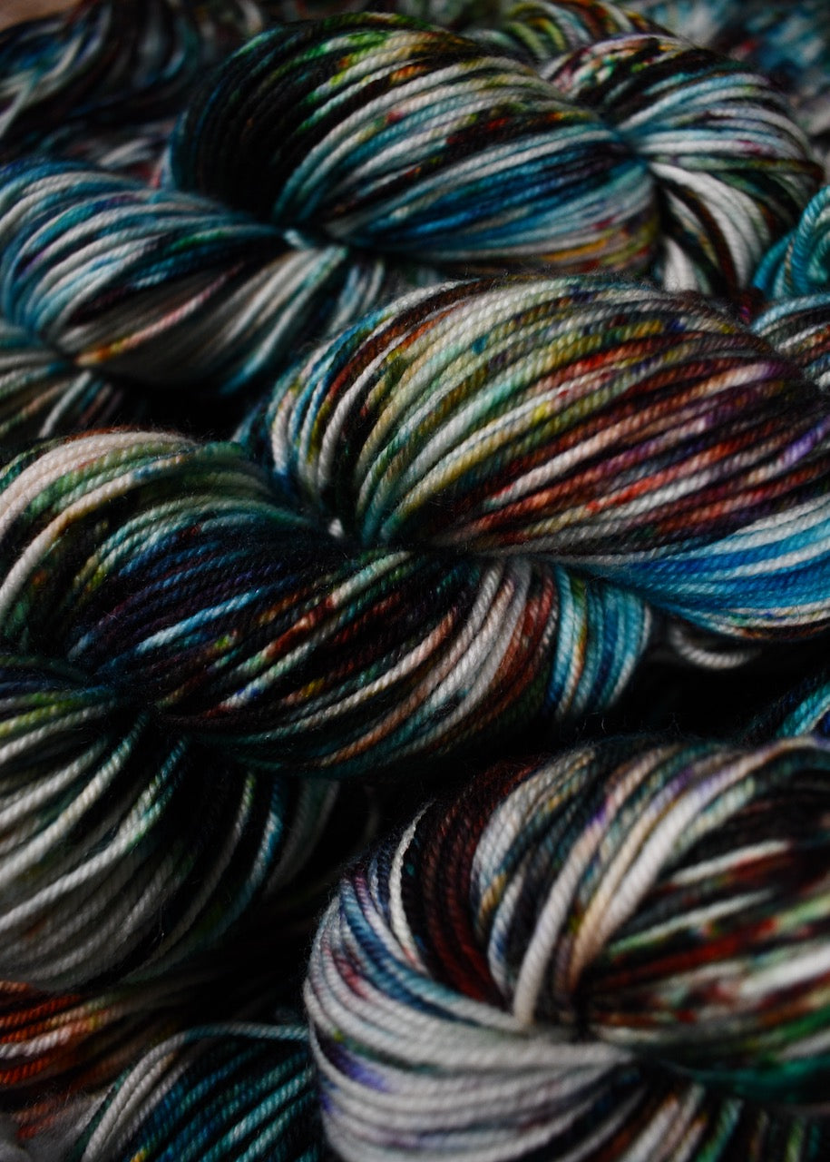 Multi colour speckled merino hand dyed worsted yarn.