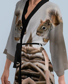 Woman wearing a kimono-style dress with a squirrel design