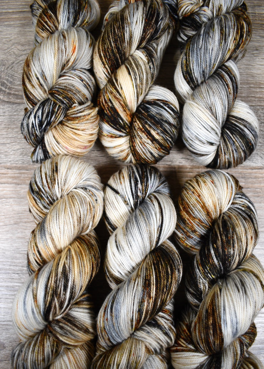 Neutral speckled gray and brown hand dyed merino cashmere sock yarn.