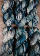 Teal green and gray hand dyed merino cashmere sock yarn.