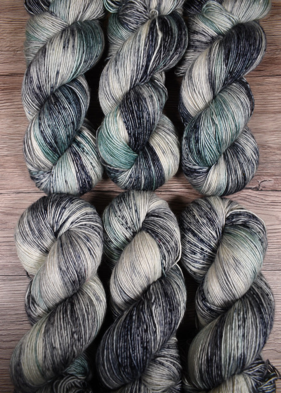 Gray and light green hand dyed merino cashmere yarn.