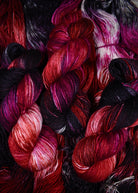 Red hand dyed merino, cashmere, silk yarn.