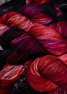 Red hand dyed merino, cashmere, silk yarn.