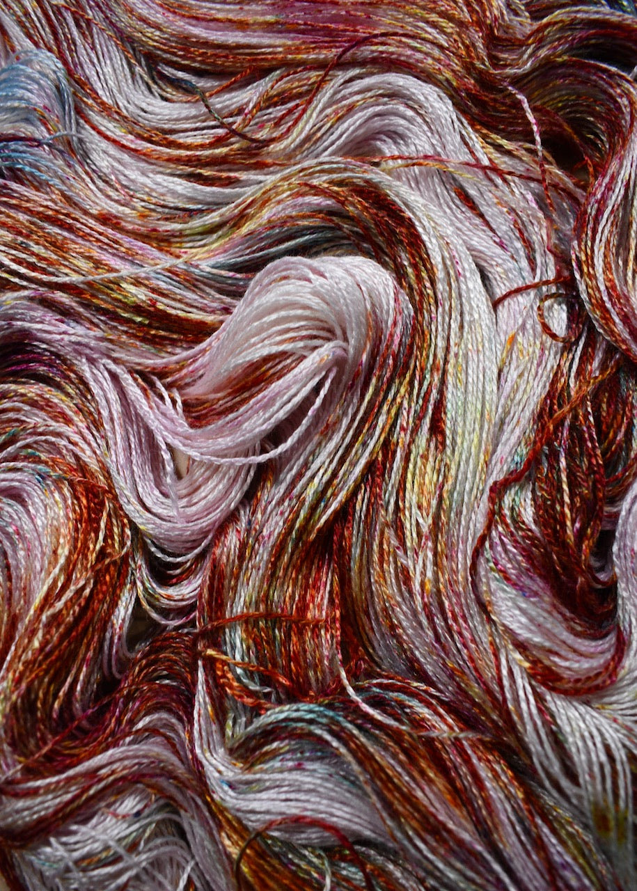 Pink speckled hand dyed bamboo sock yarn.