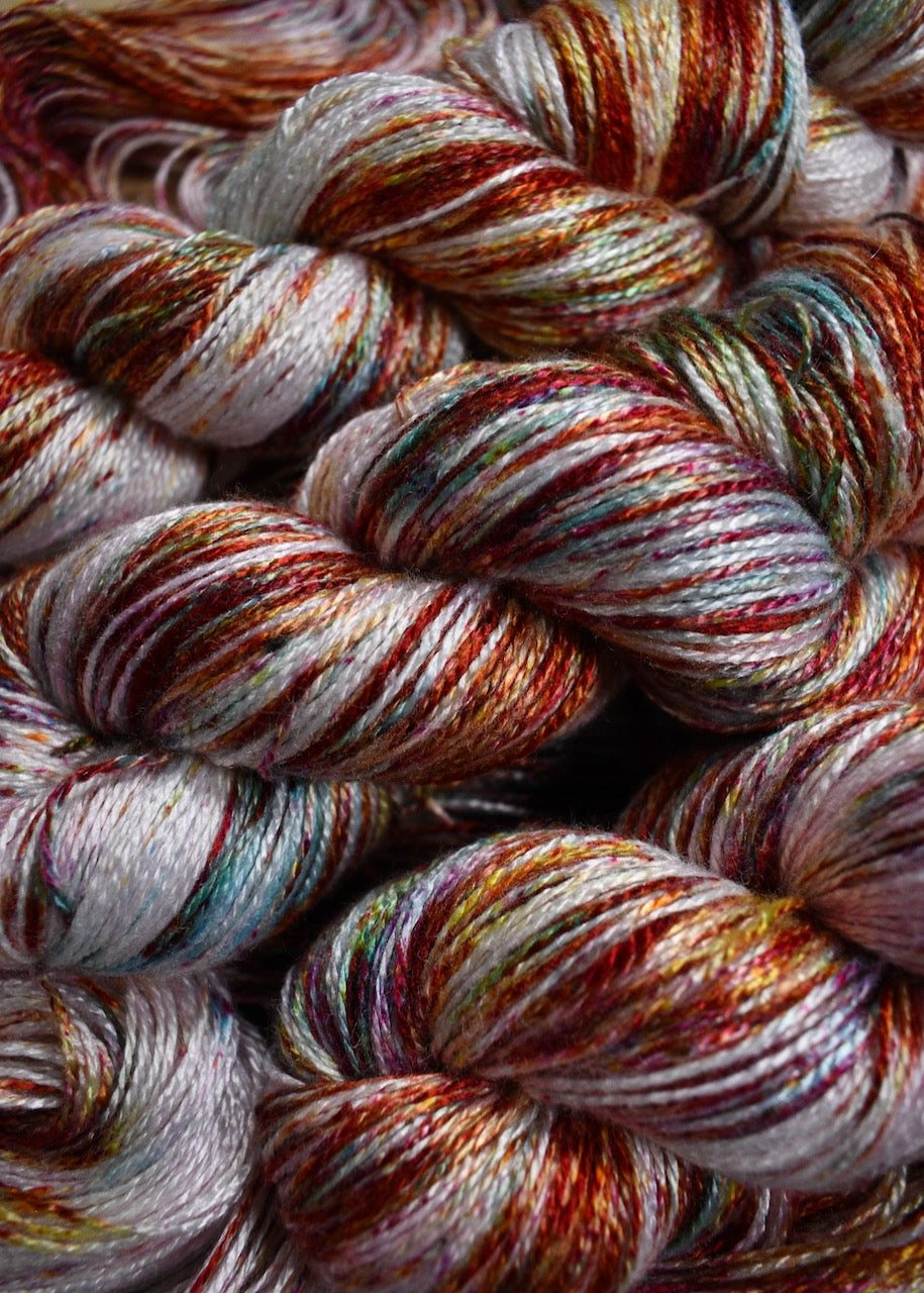 Pink speckled hand dyed bamboo sock yarn.