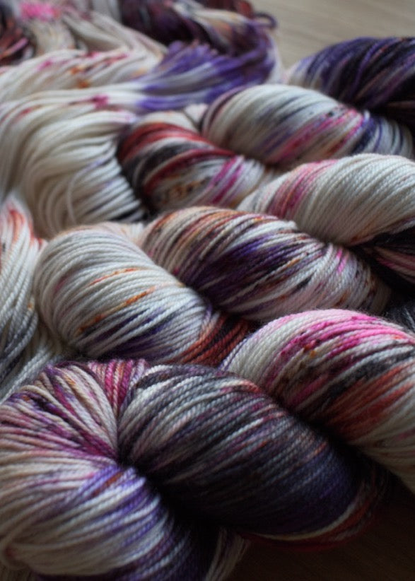 Pink, purple and orange coloured hand dyed merino cashmere sock yarn.