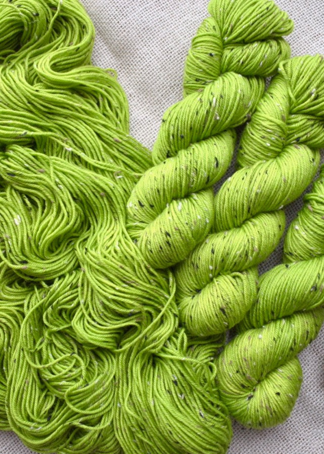 Hand dyed tweed merino yarn in lime green colour.