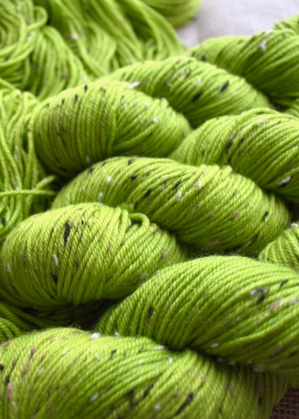 Hand dyed tweed merino yarn in lime green colour.