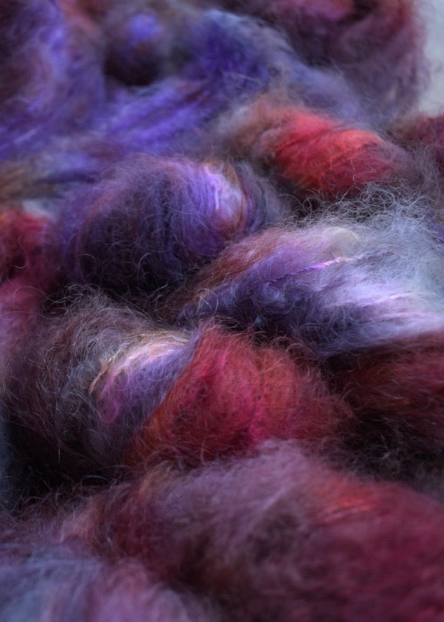 Red and purple hand dyed mohair dk weight yarn.