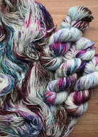 Hand dyed blue and pink speckled merino worsted yarn.