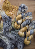 Yellow and gray hand dyed merino yarn.