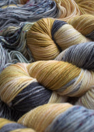 Yellow and gray hand dyed merino yarn.