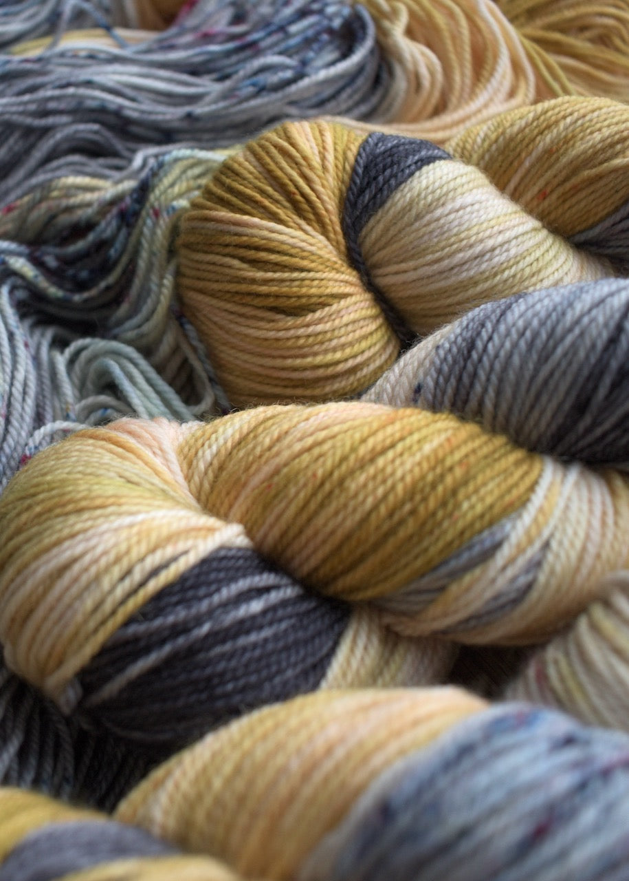 Yellow and gray hand dyed merino yarn.