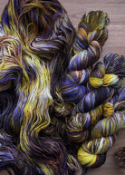 Purple and yellow hand dyed merino sport weight yarn.