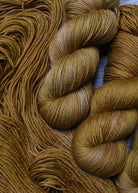 Golden brown hand dyed merino sock yarn.