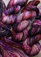 Pink orange and purple hand dyed merino yarn.