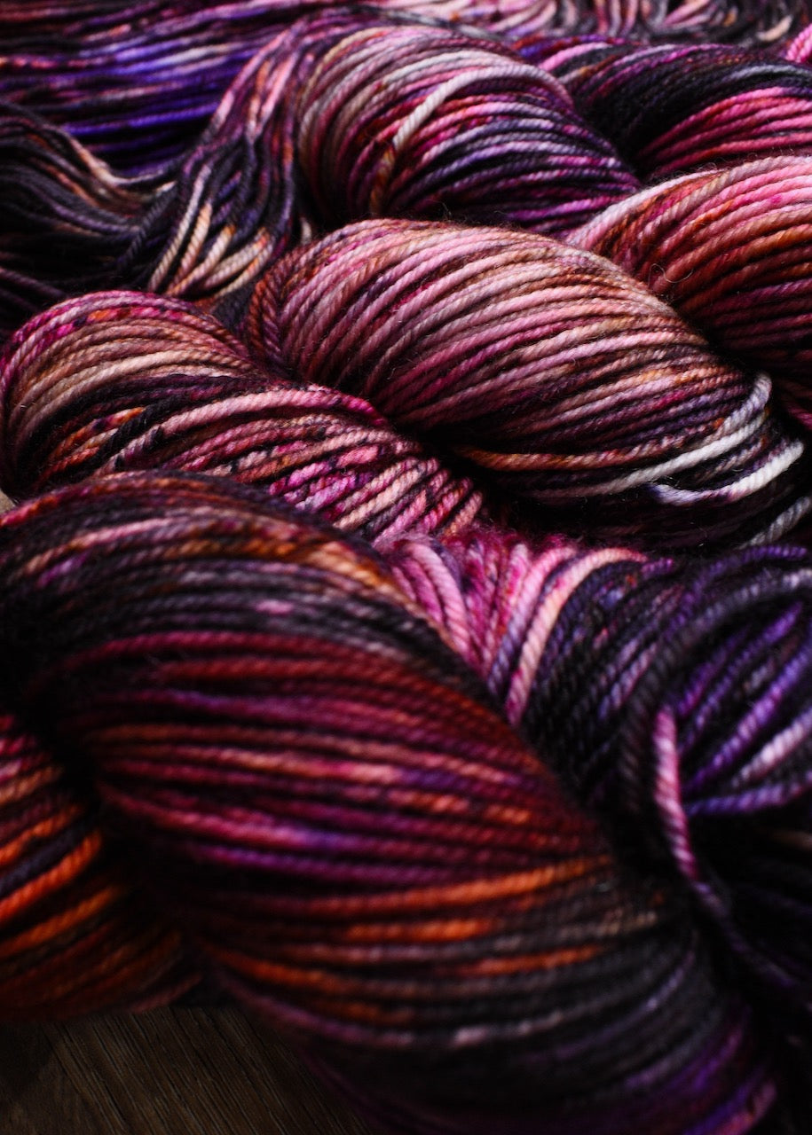 Pink orange and purple hand dyed merino yarn.