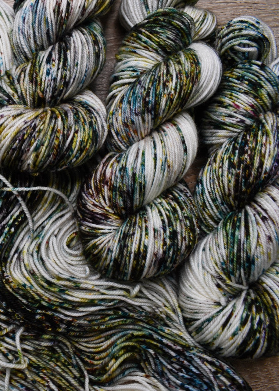 Green and brown speckled hand dyed worsted weight merino yarn.