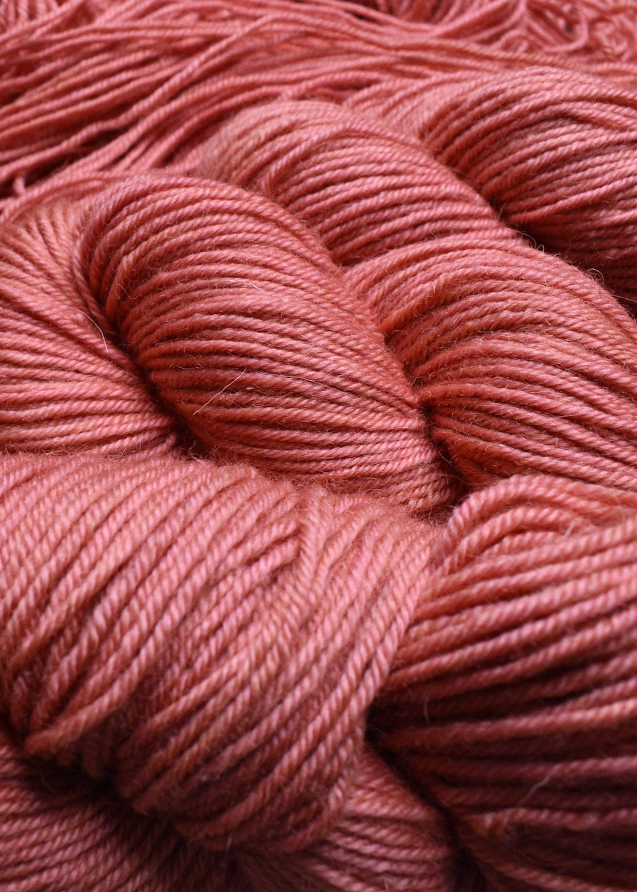 Peach colour hand dyed worsted wool yarn.