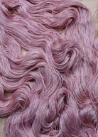 Light pink alpaca and tencel hand dyed lace yarn.