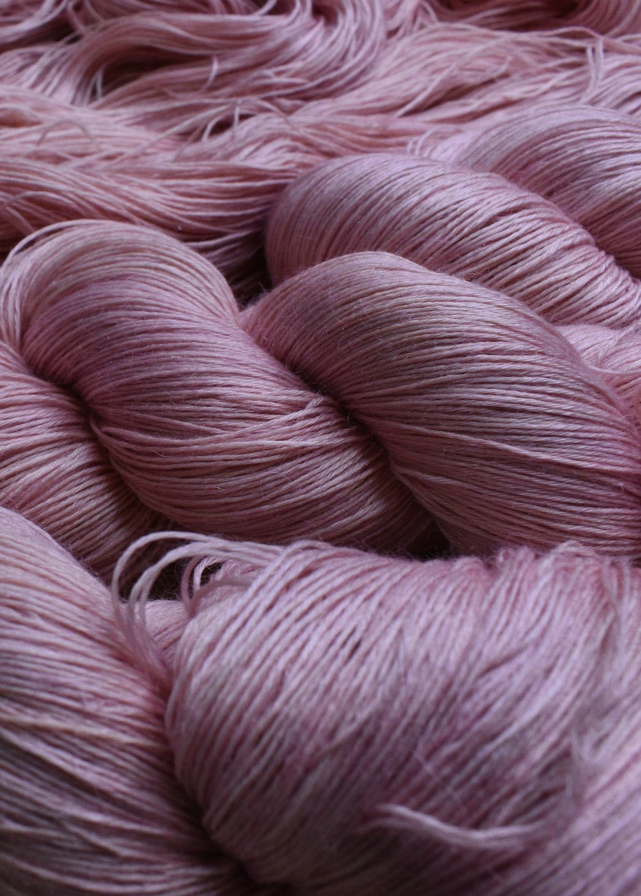 Light pink alpaca and tencel hand dyed lace yarn.
